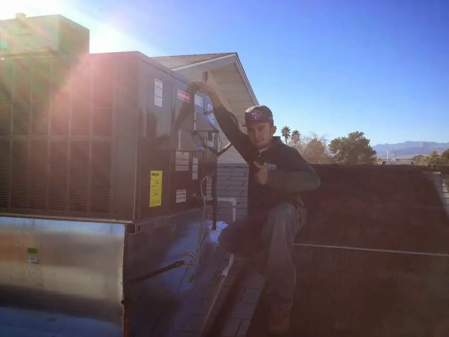 HVAC technician performing HVAC Inspection on a rooftop unit in East Grand Forks